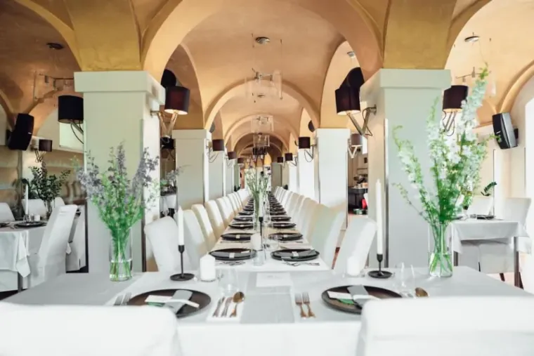 Long banquet table set under the arched golden ceiling of BRICK'S restaurant